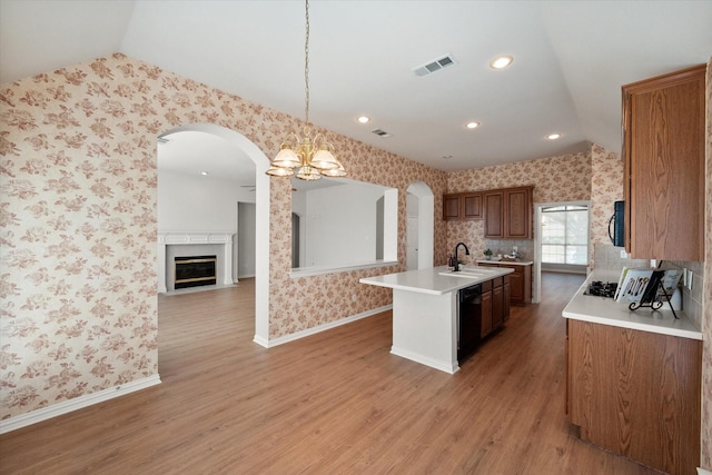 kitchen featuring light countertops, visible vents, black appliances, and wallpapered walls