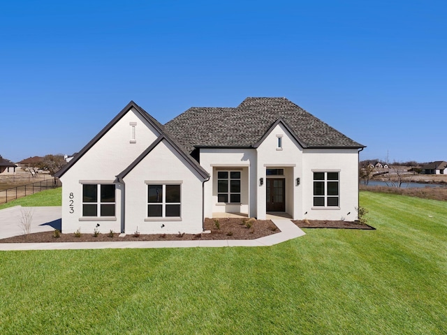 view of front of house with fence and a front lawn