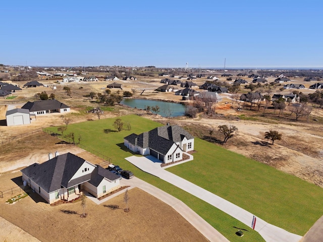 birds eye view of property with a water view and a residential view