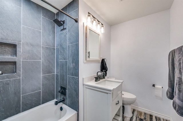 bathroom featuring bathtub / shower combination, toilet, vanity, wood finished floors, and baseboards