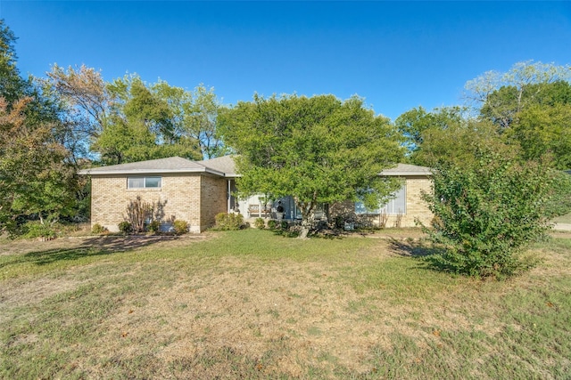 view of front of property with brick siding and a front yard