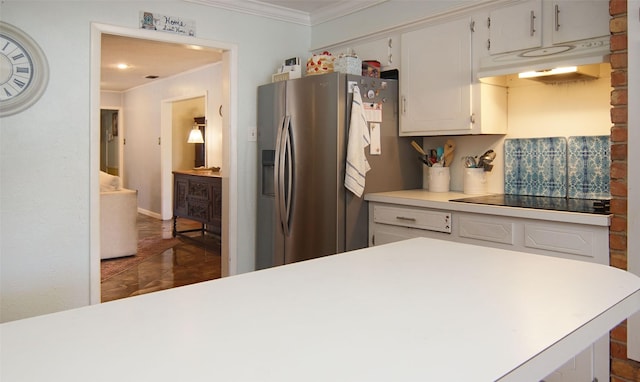 kitchen with under cabinet range hood, white cabinetry, light countertops, stainless steel refrigerator with ice dispenser, and crown molding