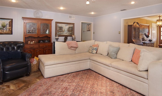 living area featuring a textured ceiling, ornamental molding, visible vents, and recessed lighting