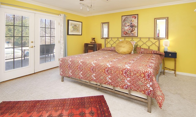 carpeted bedroom featuring french doors, crown molding, rail lighting, access to outside, and baseboards