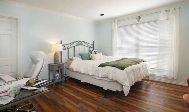 bedroom featuring wood finished floors and crown molding