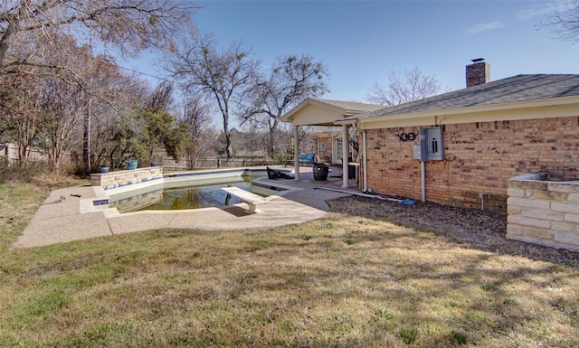 view of yard featuring a patio area and a fenced in pool