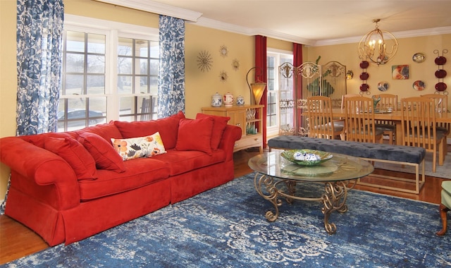 living area featuring ornamental molding, wood finished floors, and an inviting chandelier