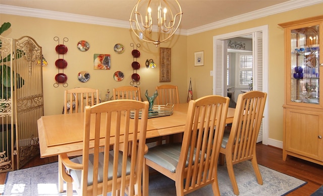 dining area featuring crown molding, wood finished floors, and an inviting chandelier