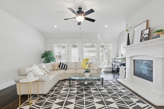 living area with a premium fireplace, recessed lighting, and wood finished floors