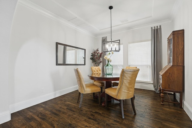 dining space with crown molding, wood finished floors, visible vents, and baseboards