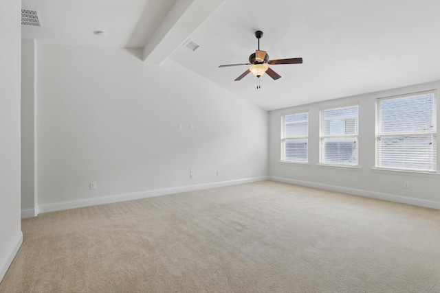 empty room with lofted ceiling with beams, visible vents, and light carpet