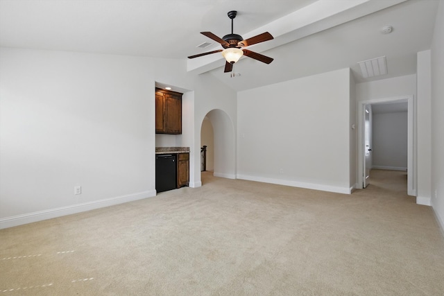 unfurnished living room featuring lofted ceiling with beams, arched walkways, light colored carpet, and a ceiling fan