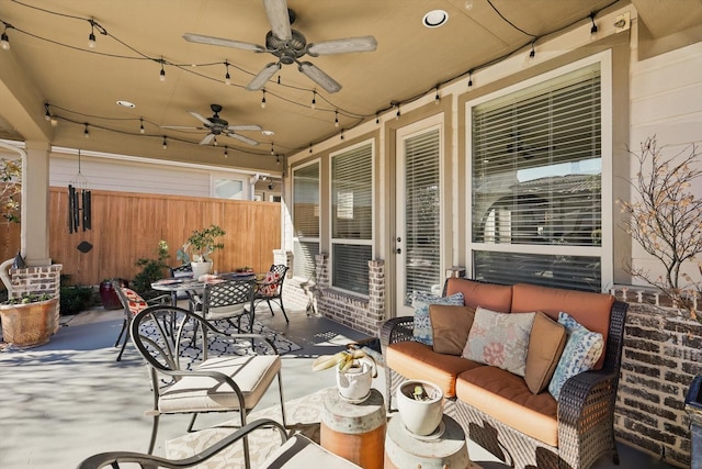 view of patio with outdoor dining space, outdoor lounge area, ceiling fan, and fence