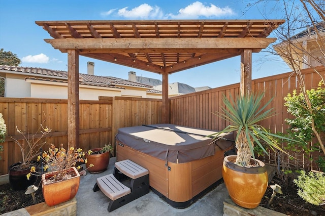 view of patio featuring a fenced backyard, a pergola, and a hot tub