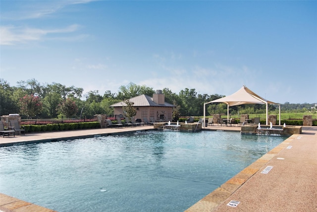 community pool featuring a gazebo, a patio, and fence