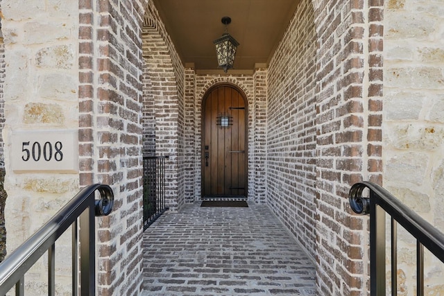 doorway to property with brick siding