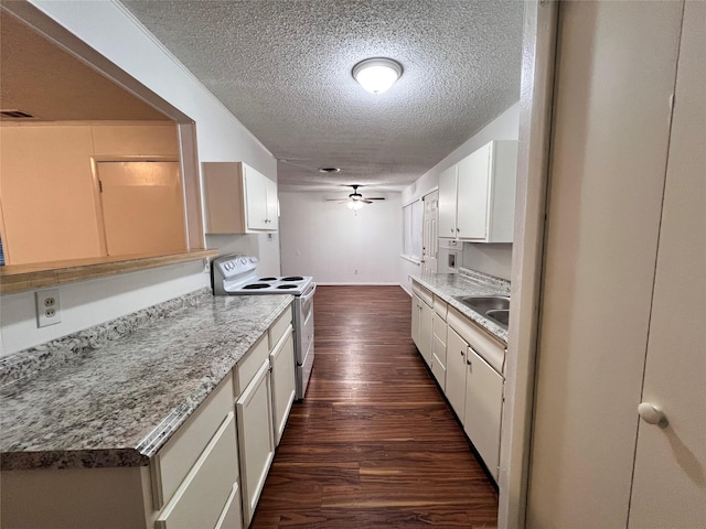 kitchen with a ceiling fan, electric stove, dark wood-style floors, light countertops, and a textured ceiling