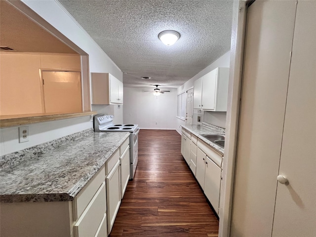 kitchen with a ceiling fan, dark wood-style floors, white electric range, white cabinetry, and a sink