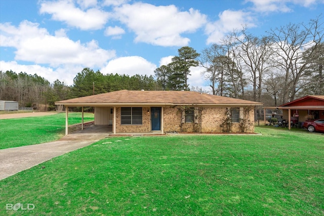 view of front of property featuring a carport, concrete driveway, brick siding, and a front lawn