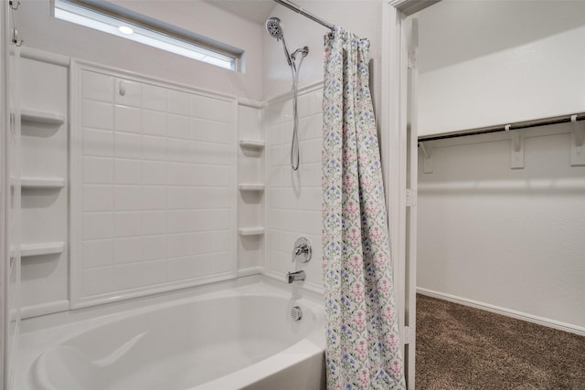 bathroom with baseboards and shower / tub combo with curtain