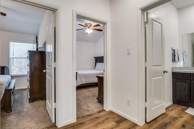 hall with wood finished floors and baseboards