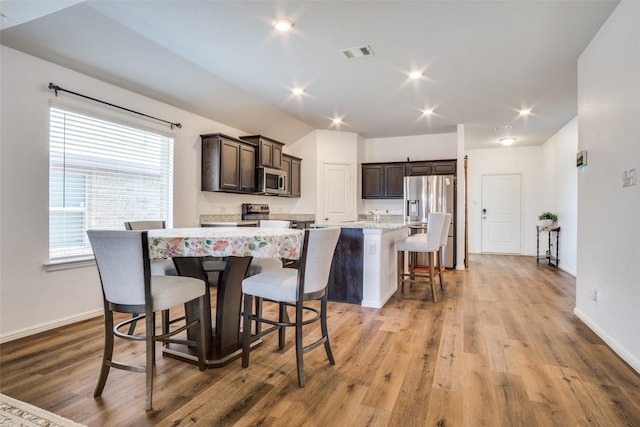 dining area with light wood-type flooring, visible vents, baseboards, and recessed lighting