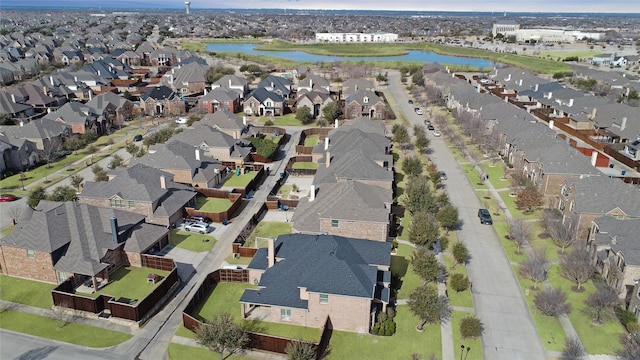 drone / aerial view featuring a residential view and a water view