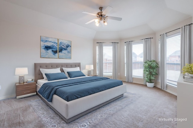 bedroom featuring a ceiling fan, light colored carpet, and baseboards