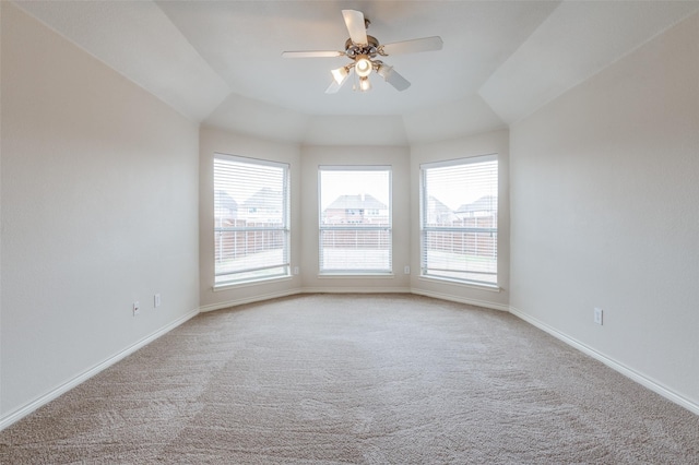 empty room featuring light colored carpet, baseboards, and ceiling fan