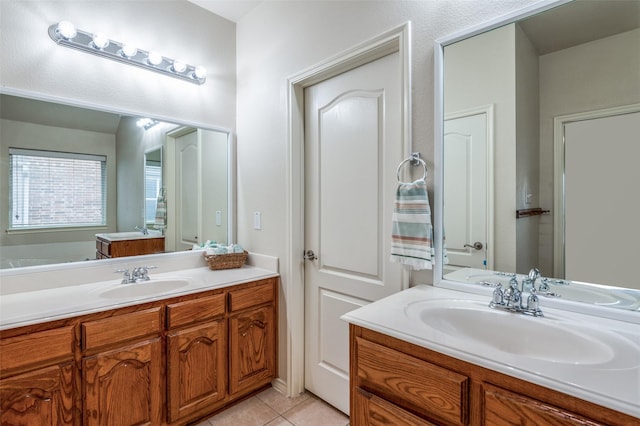 bathroom featuring tile patterned flooring, two vanities, and a sink