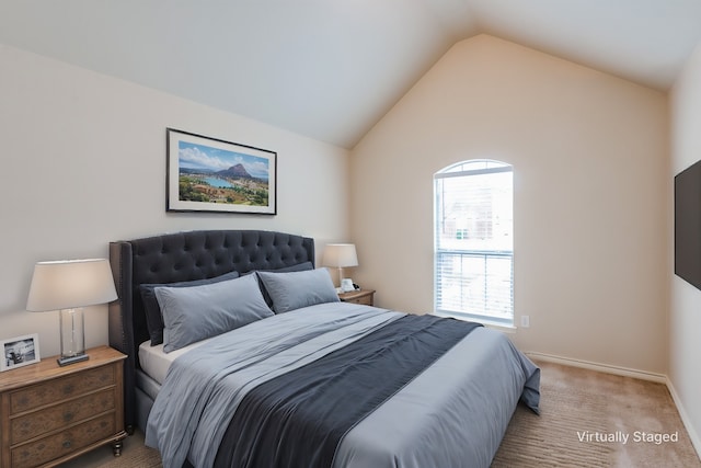 bedroom featuring lofted ceiling, baseboards, and light carpet