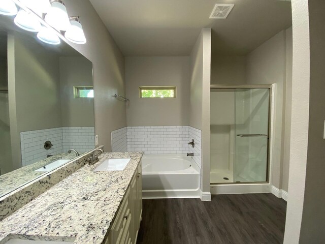 full bath featuring a stall shower, visible vents, vanity, and wood finished floors