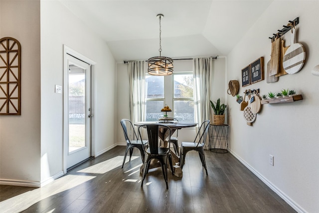 dining room with baseboards, vaulted ceiling, and dark wood-type flooring