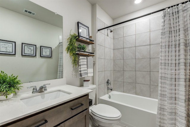 full bathroom featuring toilet, vanity, shower / bath combination with curtain, and visible vents