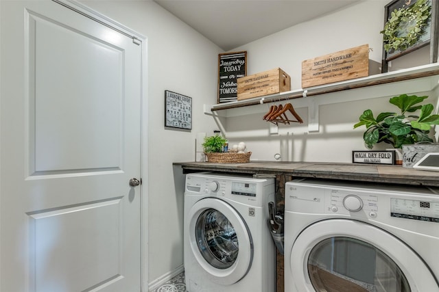 clothes washing area with washer and dryer and laundry area