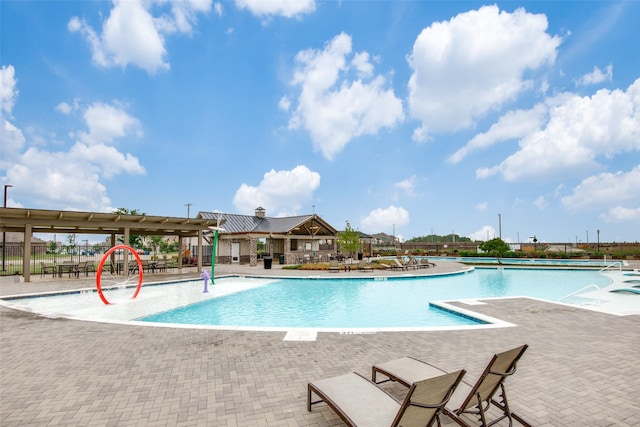 community pool with a patio and fence