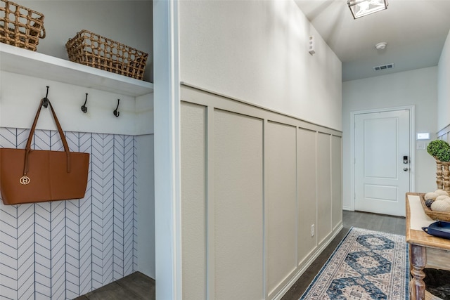 mudroom with visible vents and dark wood finished floors