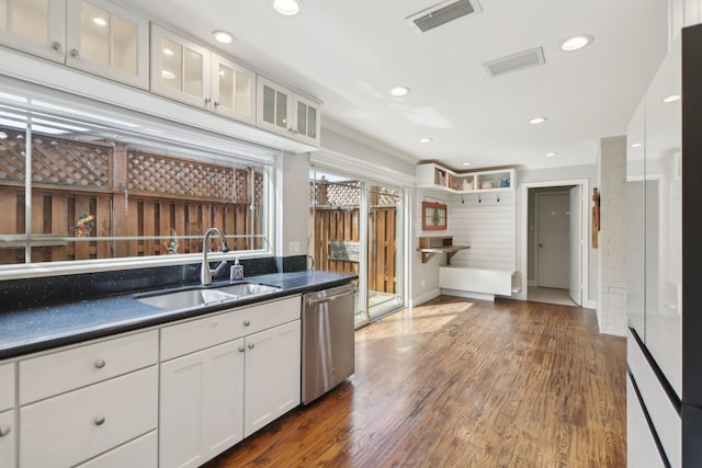 kitchen featuring a sink, dark countertops, white cabinets, and dishwasher