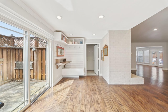 interior space with baseboards, wood finished floors, and recessed lighting