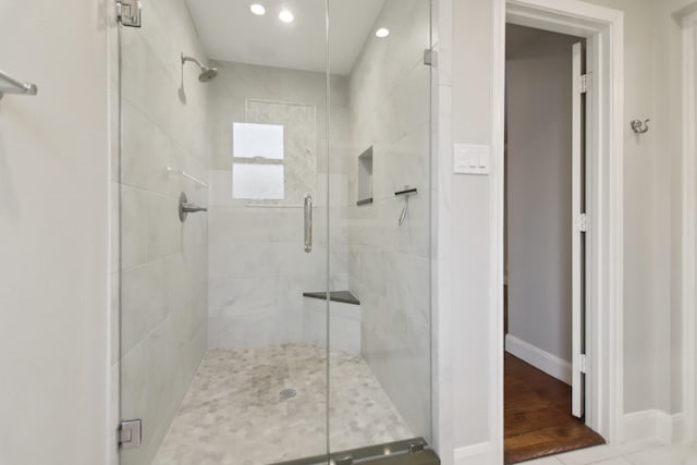 bathroom with a stall shower, recessed lighting, and baseboards