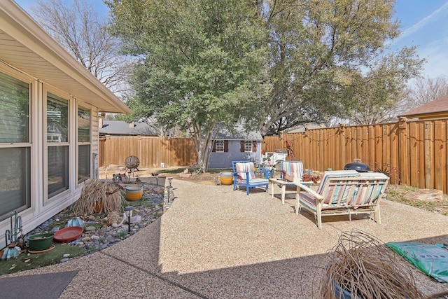 view of patio / terrace with an outbuilding, a storage shed, and a fenced backyard