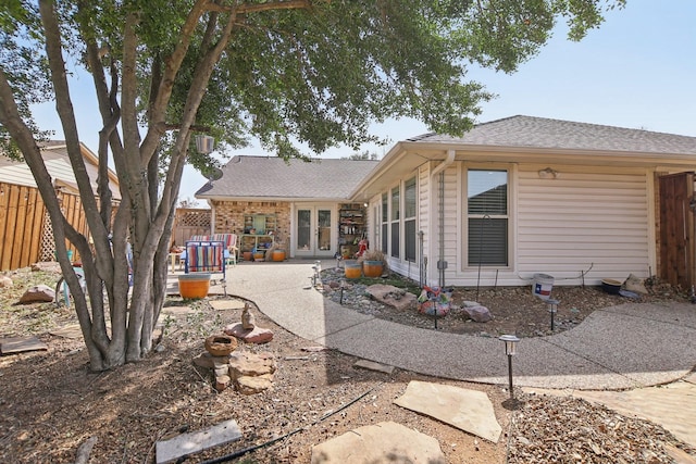 back of property with french doors, a patio area, and fence