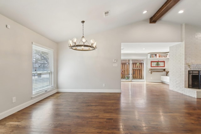 interior space featuring a fireplace, vaulted ceiling with beams, visible vents, and wood finished floors