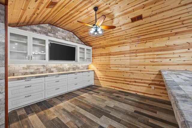 kitchen with lofted ceiling, dark wood-style flooring, wood ceiling, white cabinetry, and glass insert cabinets