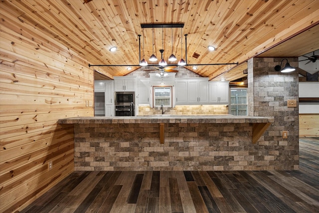 kitchen with white cabinets, a ceiling fan, wood ceiling, appliances with stainless steel finishes, and a sink