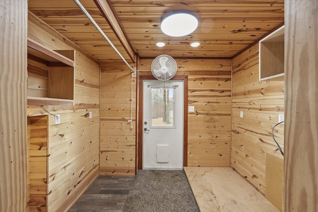 entryway featuring wood ceiling and wooden walls