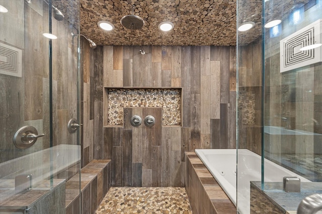 full bathroom with a whirlpool tub and a tile shower