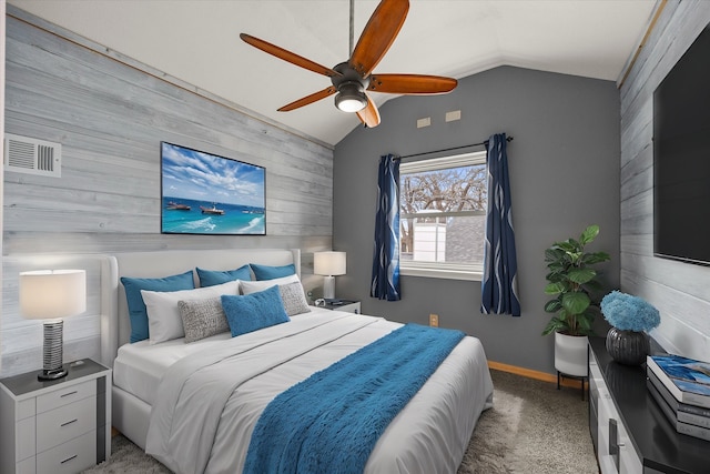 bedroom with lofted ceiling, ceiling fan, light colored carpet, wood walls, and visible vents