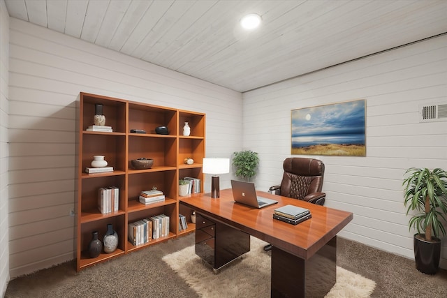 carpeted office space featuring visible vents and wood ceiling