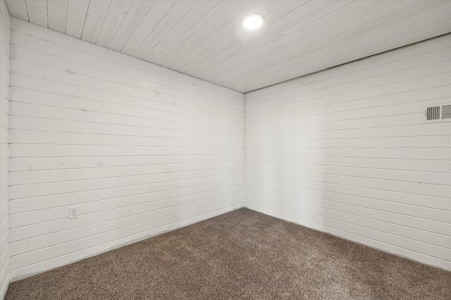 unfurnished room featuring recessed lighting, wood ceiling, carpet flooring, and wooden walls